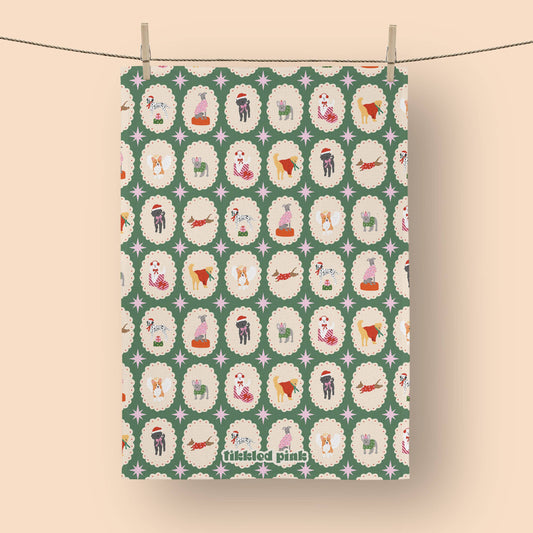 Patterned fabric with cartoon dogs on a green background, hanging on a line.