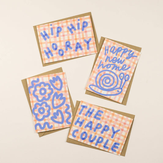 Four greeting cards with blue text and designs on a beige background