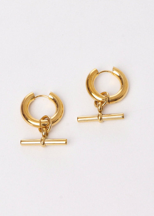 Gold hoop earrings with additional gold bars on a white background