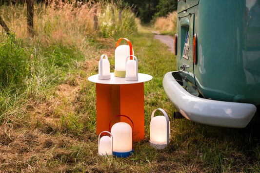 Outdoor setting with camping lights and a teal van.