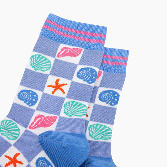 Pair of socks with shell and starfish pattern on a blue background