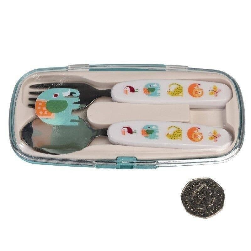 Children's cutlery set with dinosaur design in a clear case, next to a coin for scale.