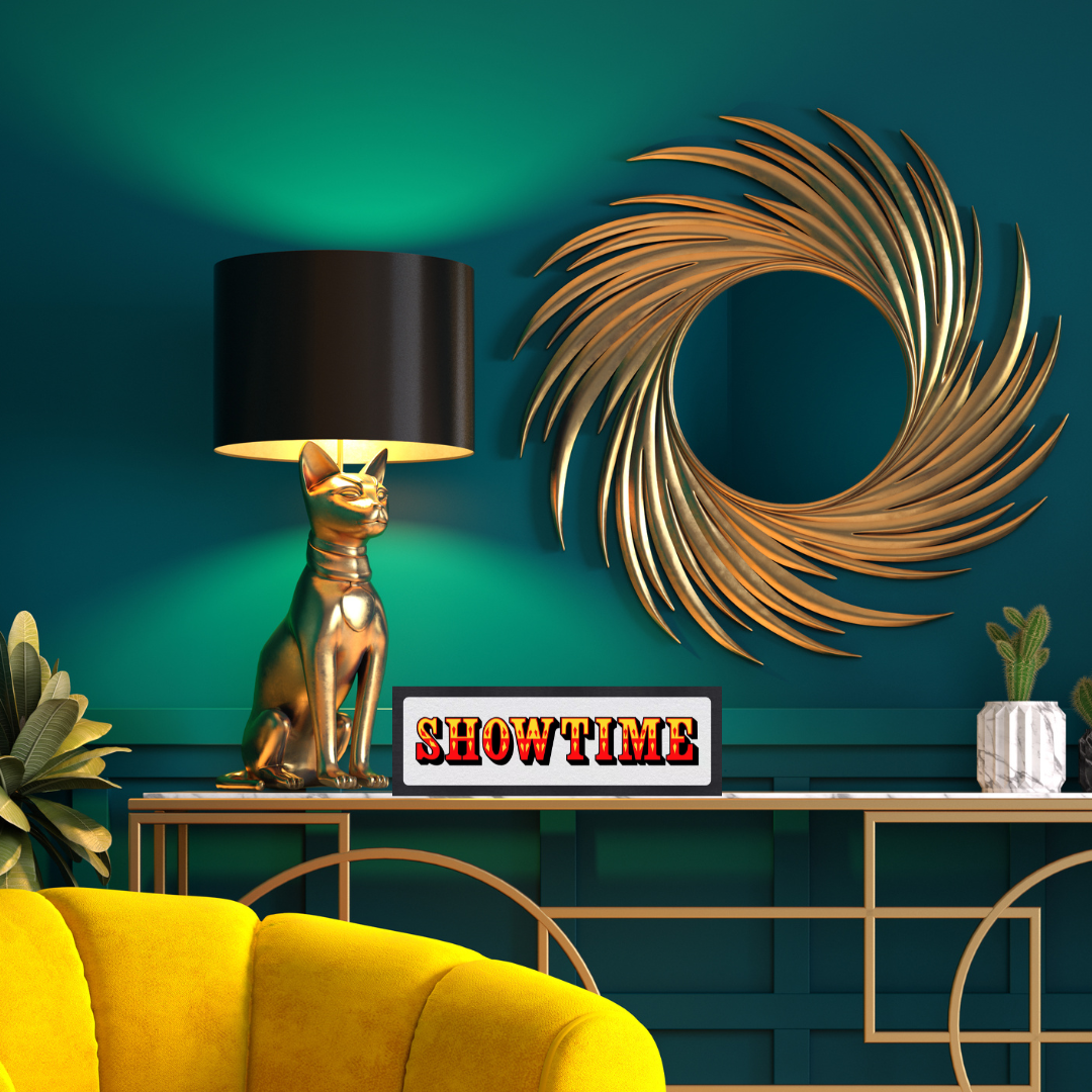 Decorative interior with gold cat lamp, 'Showtime' sign, and decorative wall piece against a teal wall.