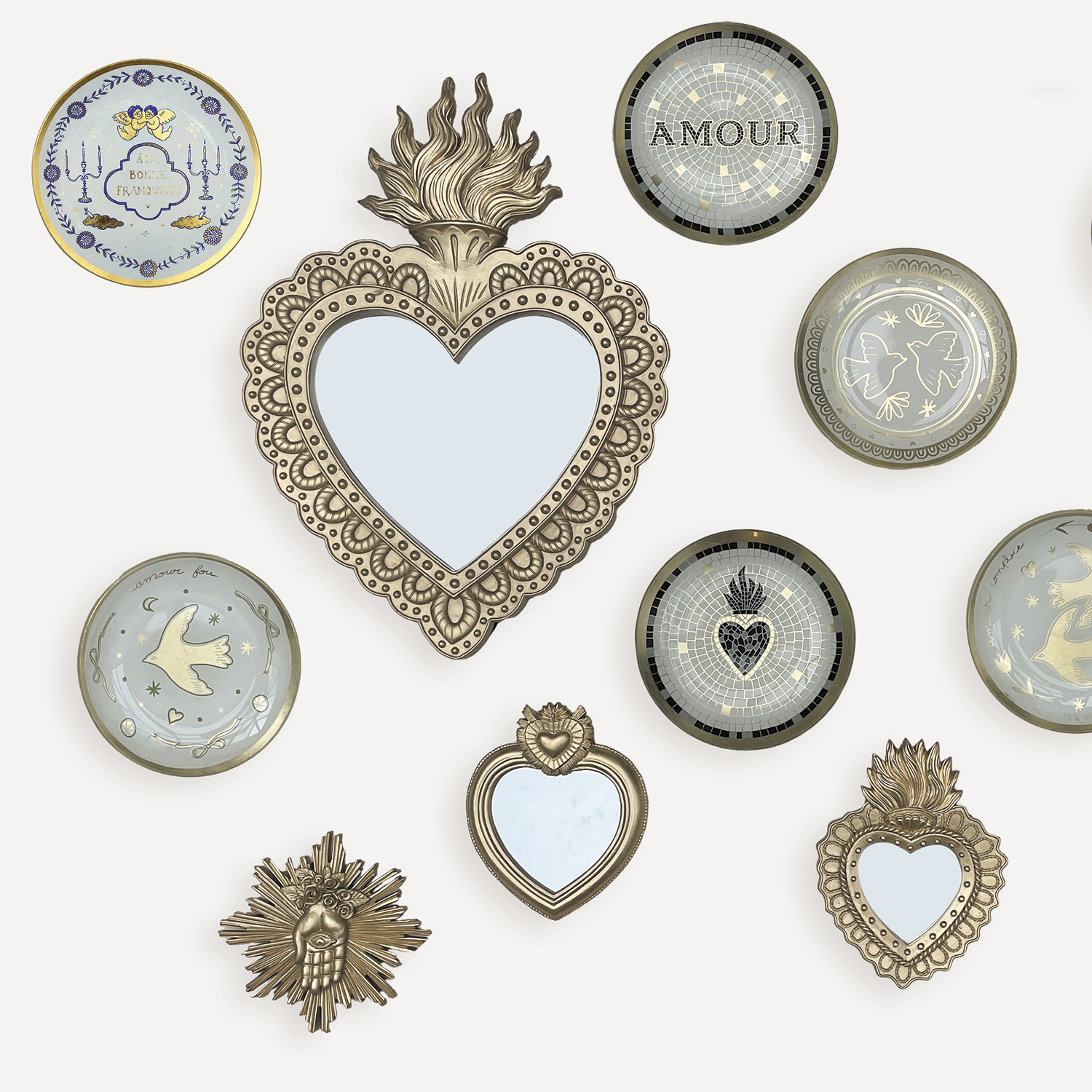 Collection of decorative heart-shaped mirrors and wall art on a white background