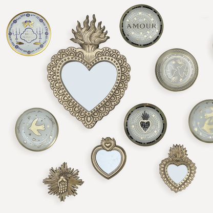Collection of decorative heart-shaped mirrors and wall art on a white background