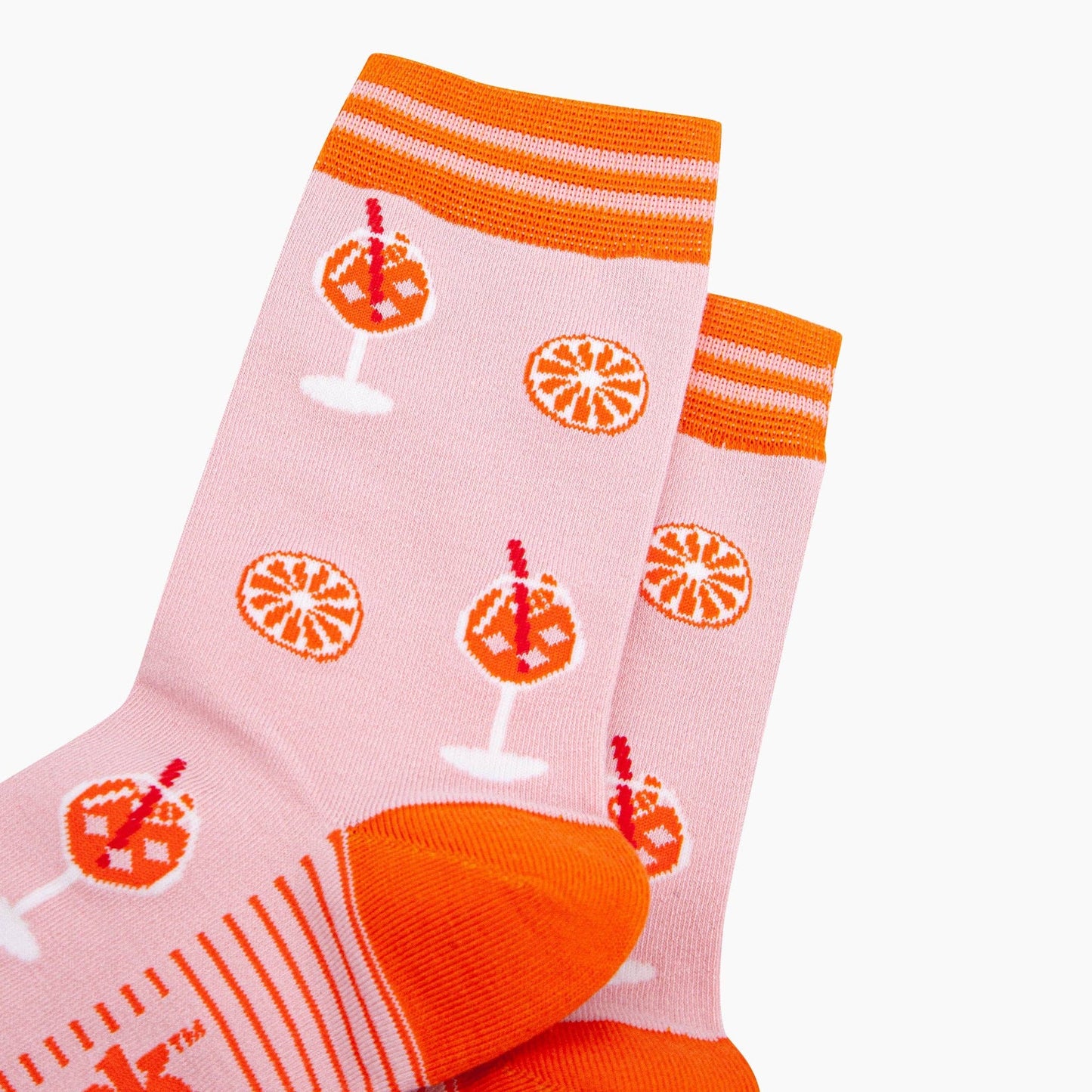 Pink socks with orange and white patterns on a white background