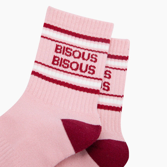 Pink socks with red and white striped pattern and 'BISOUS' text on a white background
