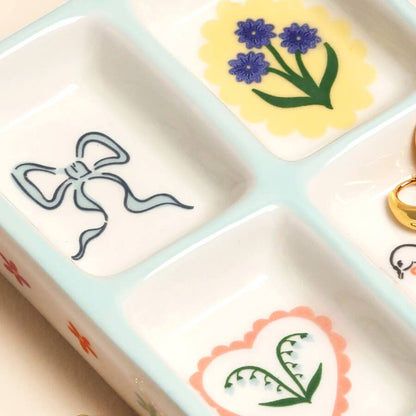 Decorative stamp set with floral and bow designs on a white background