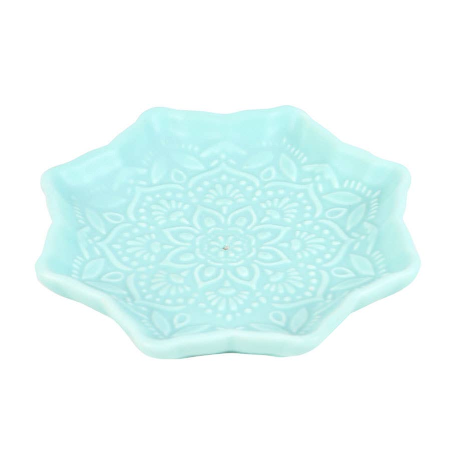 Light blue ceramic dish with a decorative pattern on a white background