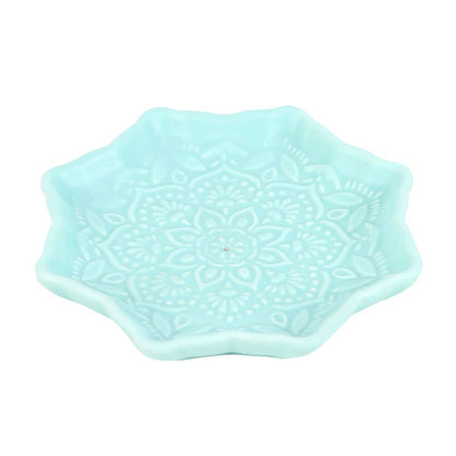 Light blue ceramic dish with a decorative pattern on a white background