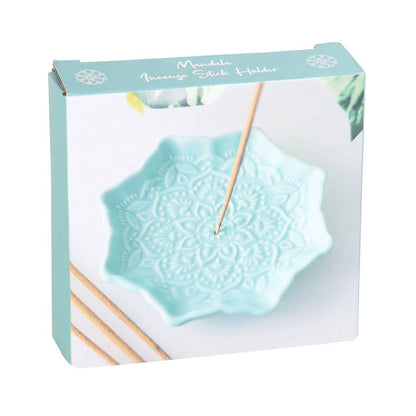 Mint green incense stick holder with packaging on a white background
