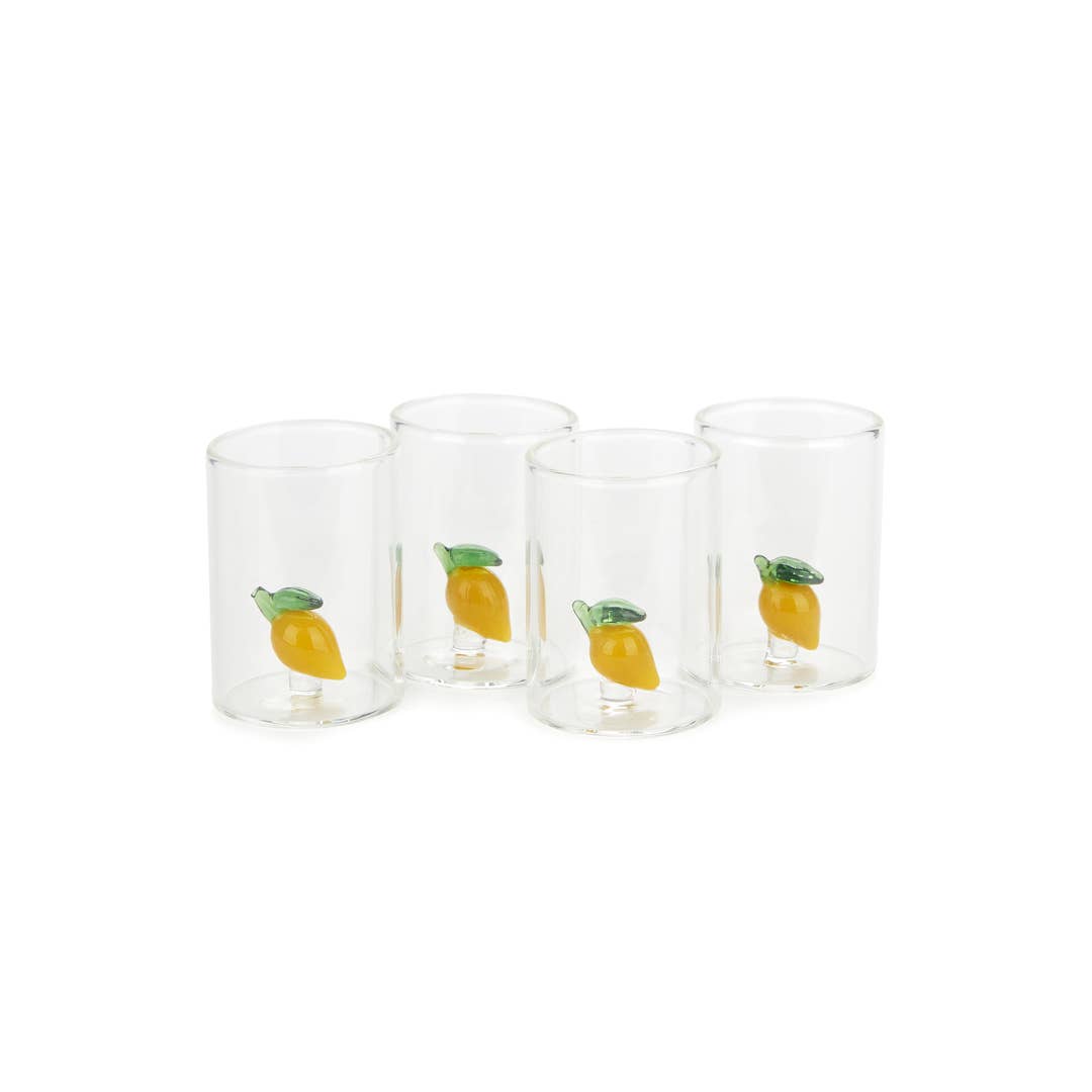Set of four clear glasses with lemon illustrations on a white background
