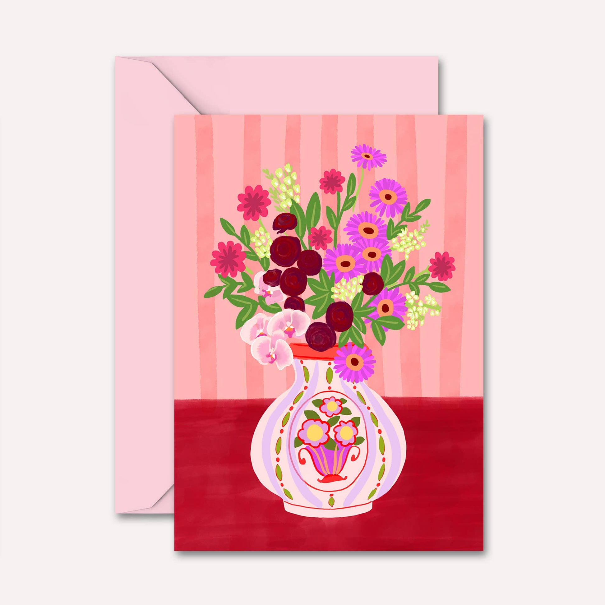 Greeting card with floral design and pink envelope on a white background