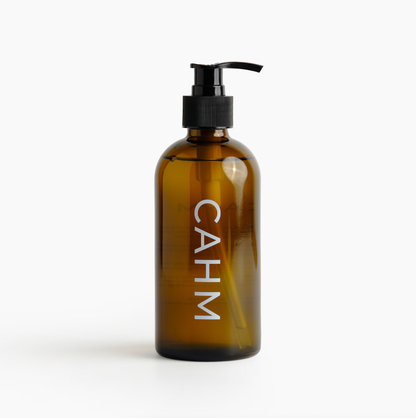Brown bottle with pump and 'CAHM' branding on a white background