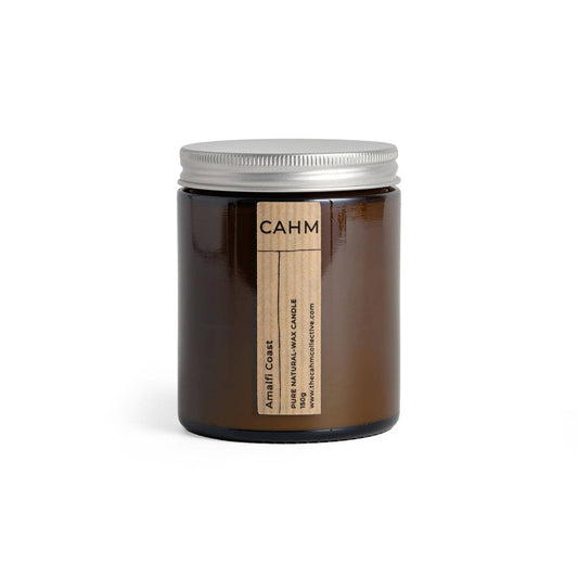 Brown candle jar with silver lid and 'CAHM' label on a white background