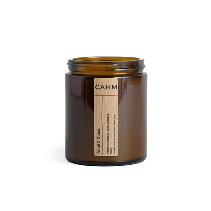 Brown candle jar with a label on a white background