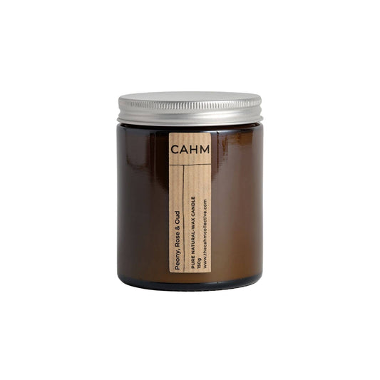 Brown candle with a silver lid on a white background, featuring the brand 'CAHM'.
