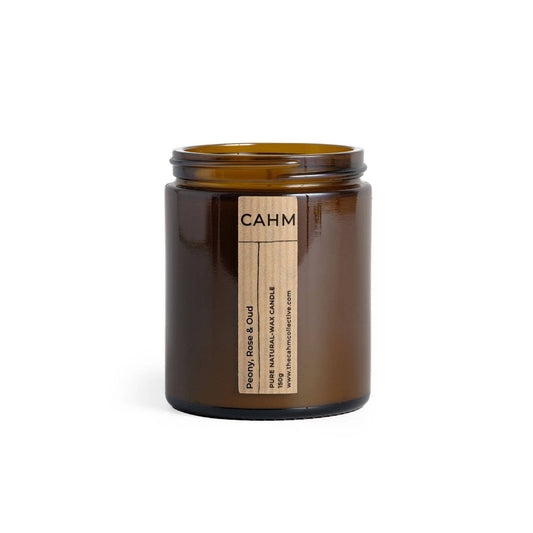 Brown candle jar with a label on a white background