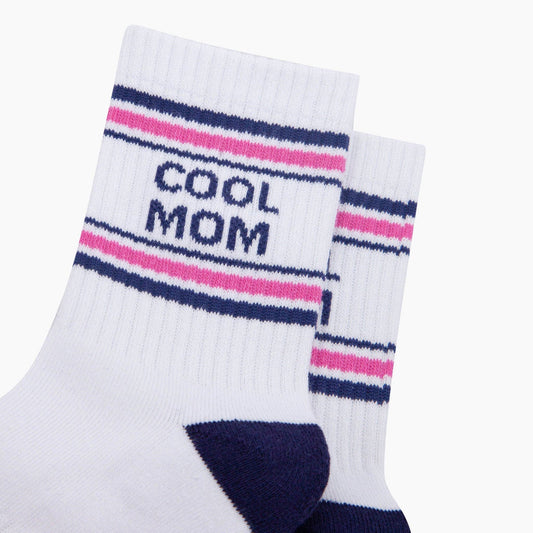 White socks with pink and blue stripes and 'COOL MOM' text on a white background