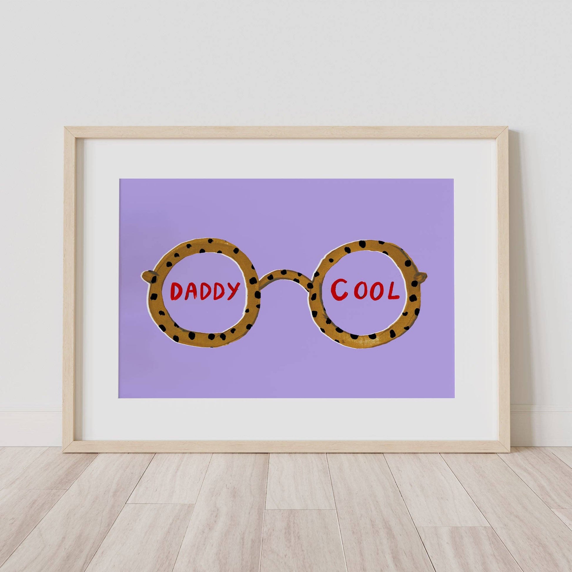 Framed artwork with leopard print glasses and 'Daddy Cool' text on a purple background.