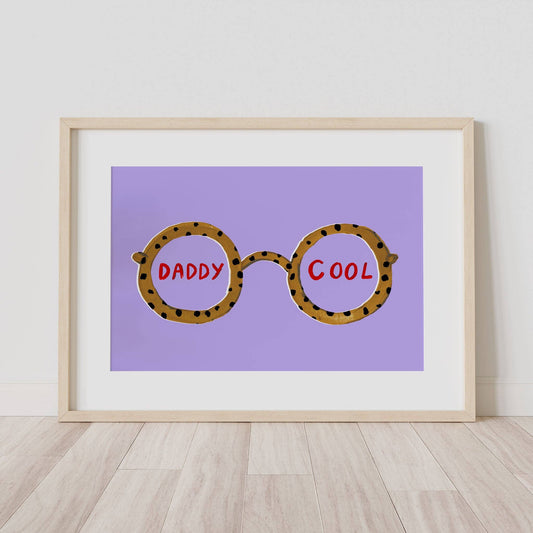 Framed artwork with leopard print glasses and 'Daddy Cool' text on a purple background.