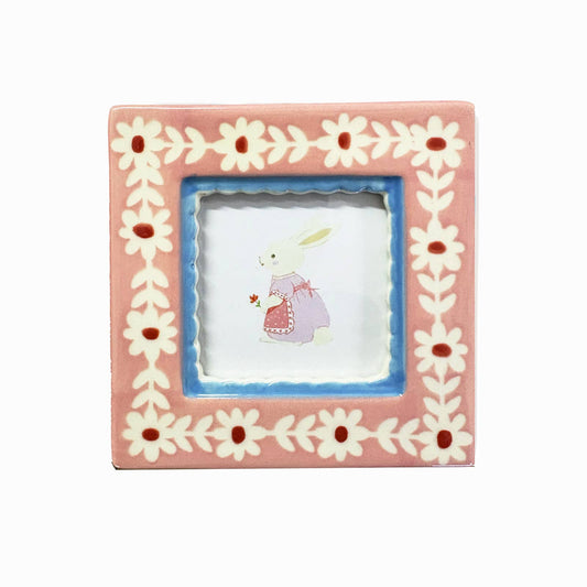 Decorative picture frame with floral design on a white background