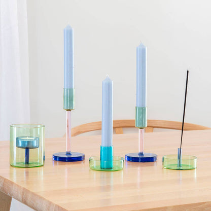 Set of candle holders with candles on a wooden table