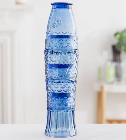 Blue textured vase on a white surface with a blurred background