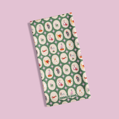 Folded green fabric with dog pattern on a light pink background