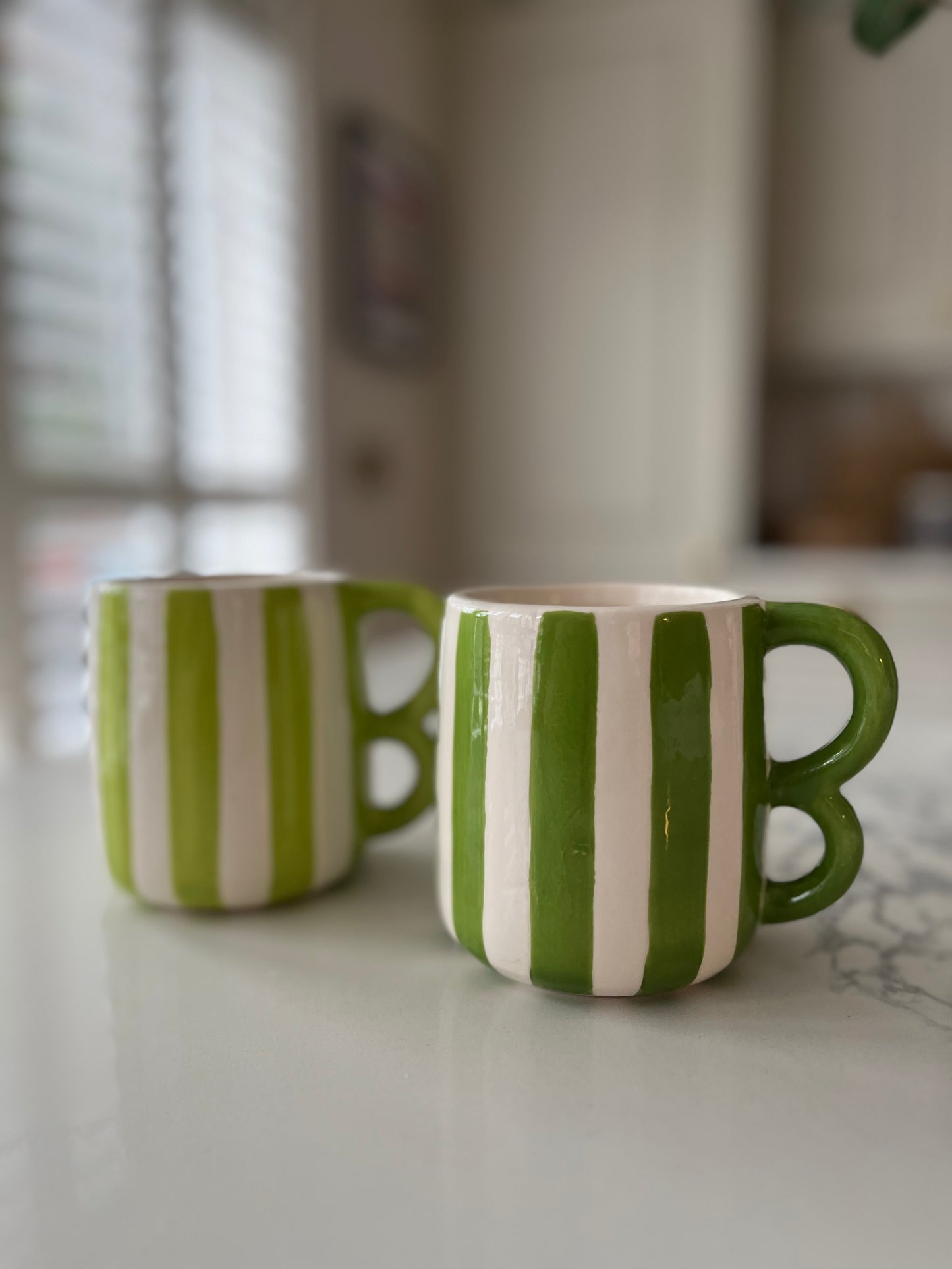 Green striped mugs with wavy handle
