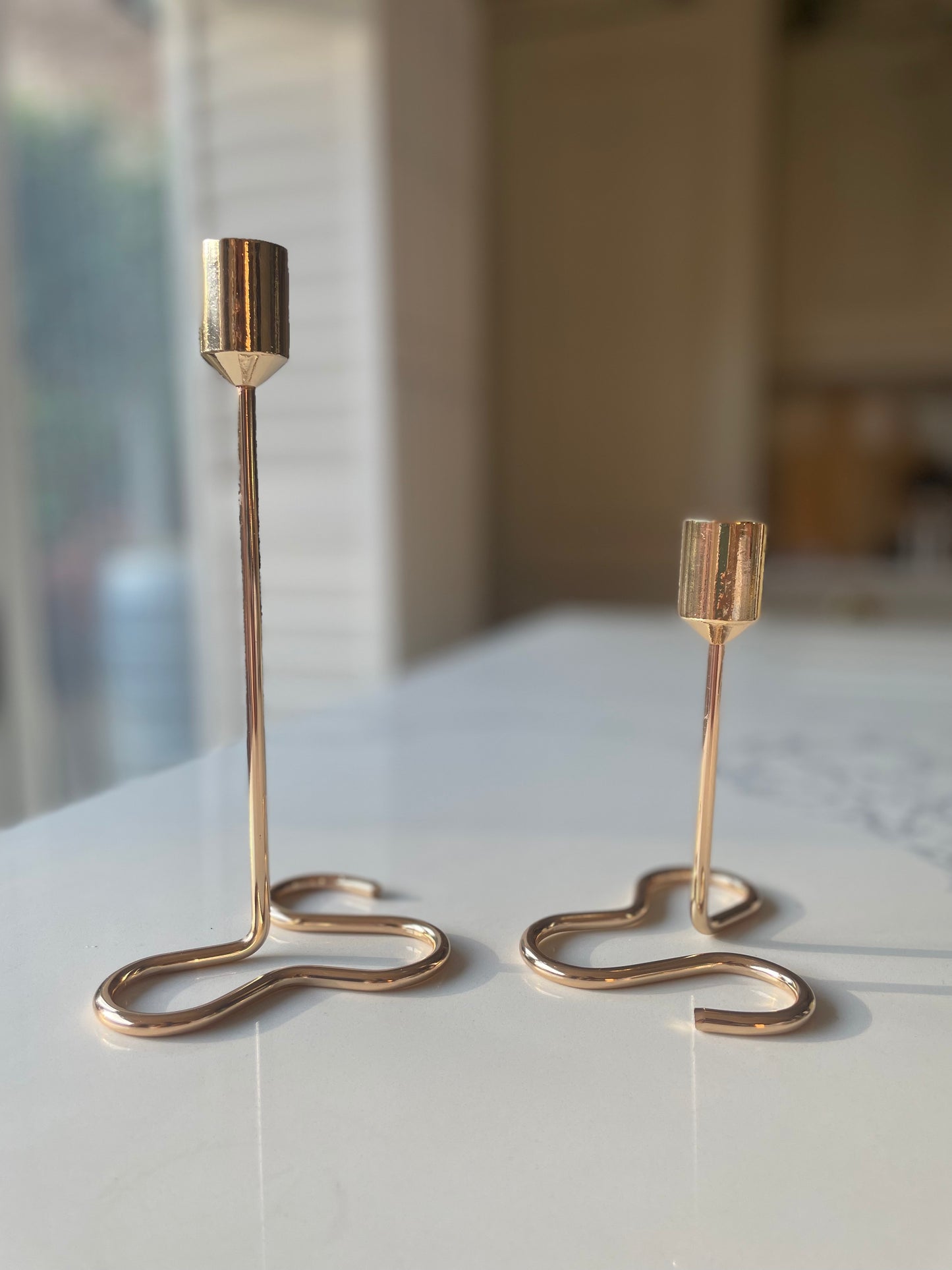 Gold candle holder with squiggly base