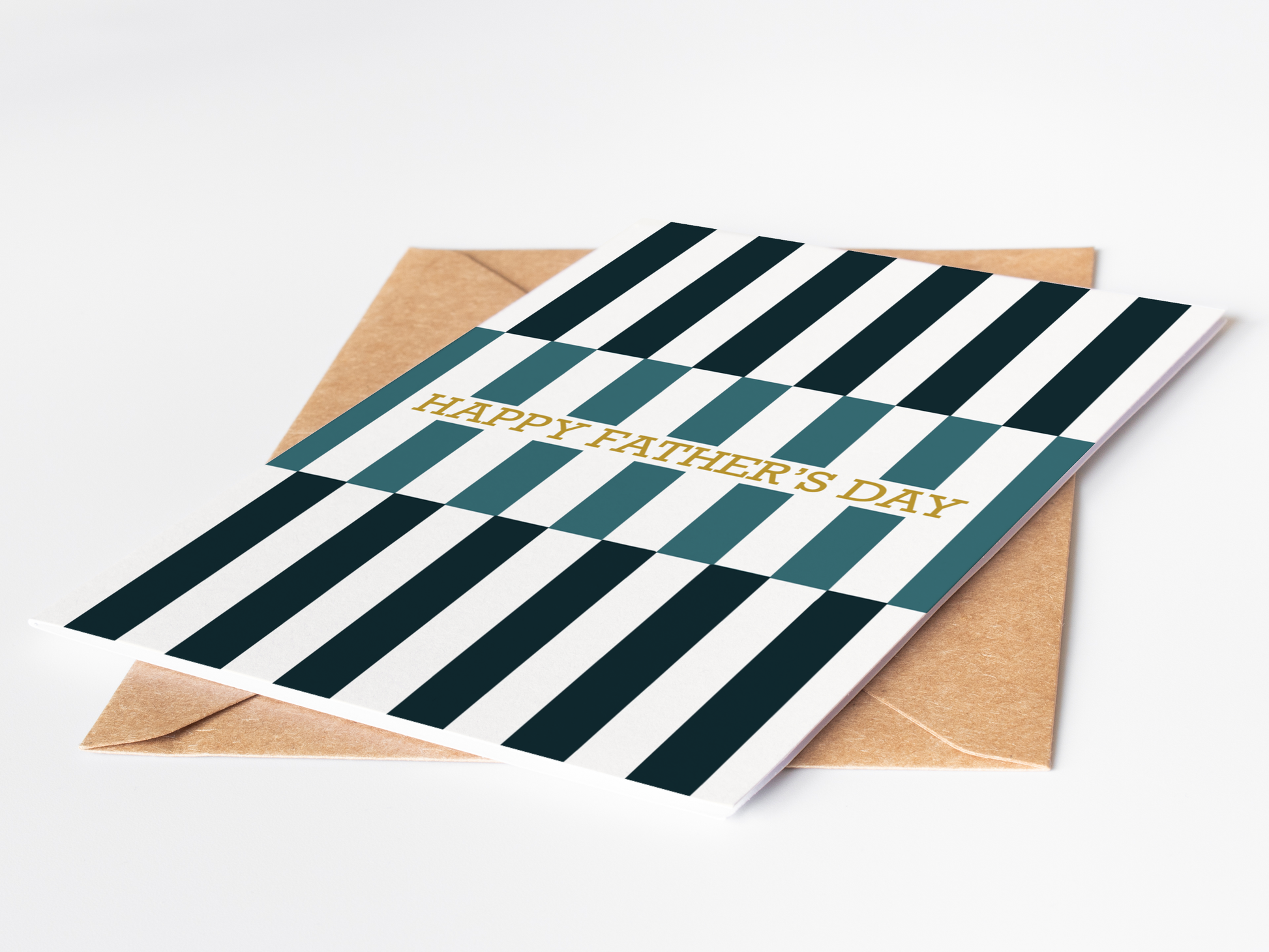 Greeting card with green and white striped design and 'Happy Father's Day' text, accompanied by a brown envelope on a light gray background.