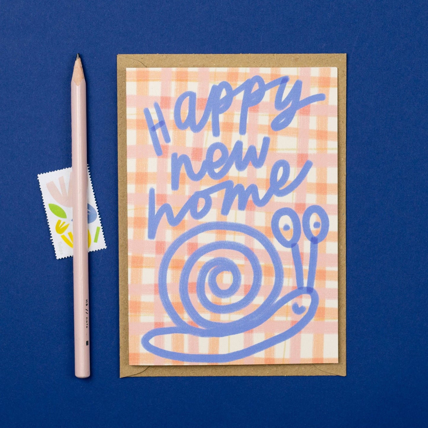 Greeting card with 'Happy new home' text and snail illustration on a blue background