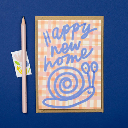 Greeting card with 'Happy new home' text and snail illustration on a blue background
