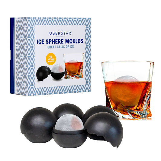 Ice sphere moulds with a glass of whiskey and packaging on a white background