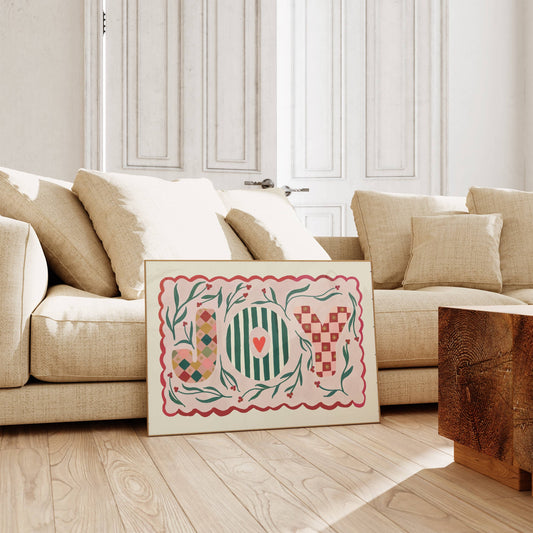 Joy Christmas print leaning on sofa