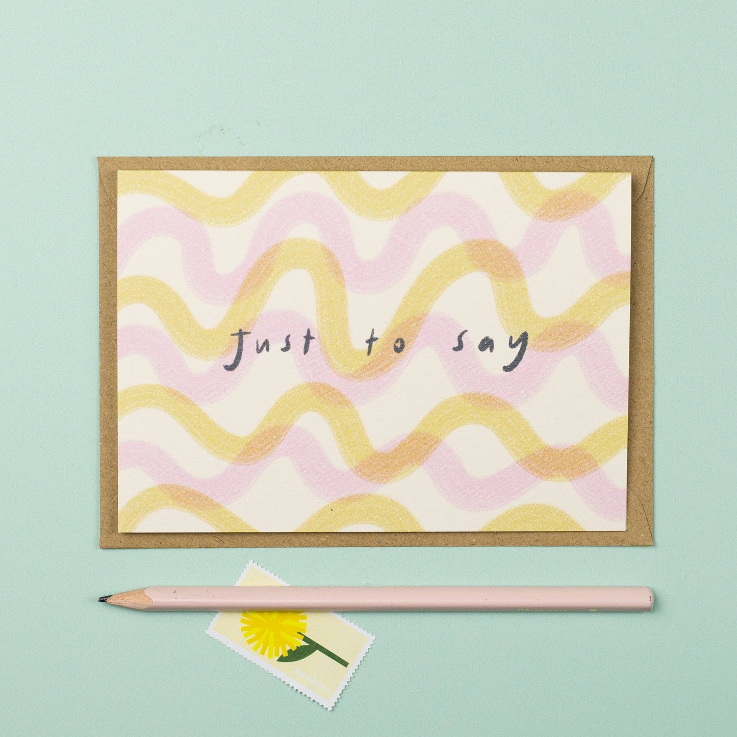 Greeting card with wavy pattern and 'Just to say' text on a light blue background
