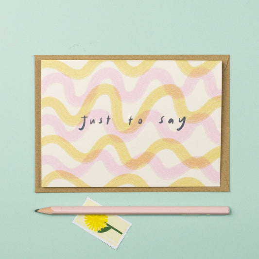 Greeting card with wavy pattern and 'Just to say' text on a light blue background
