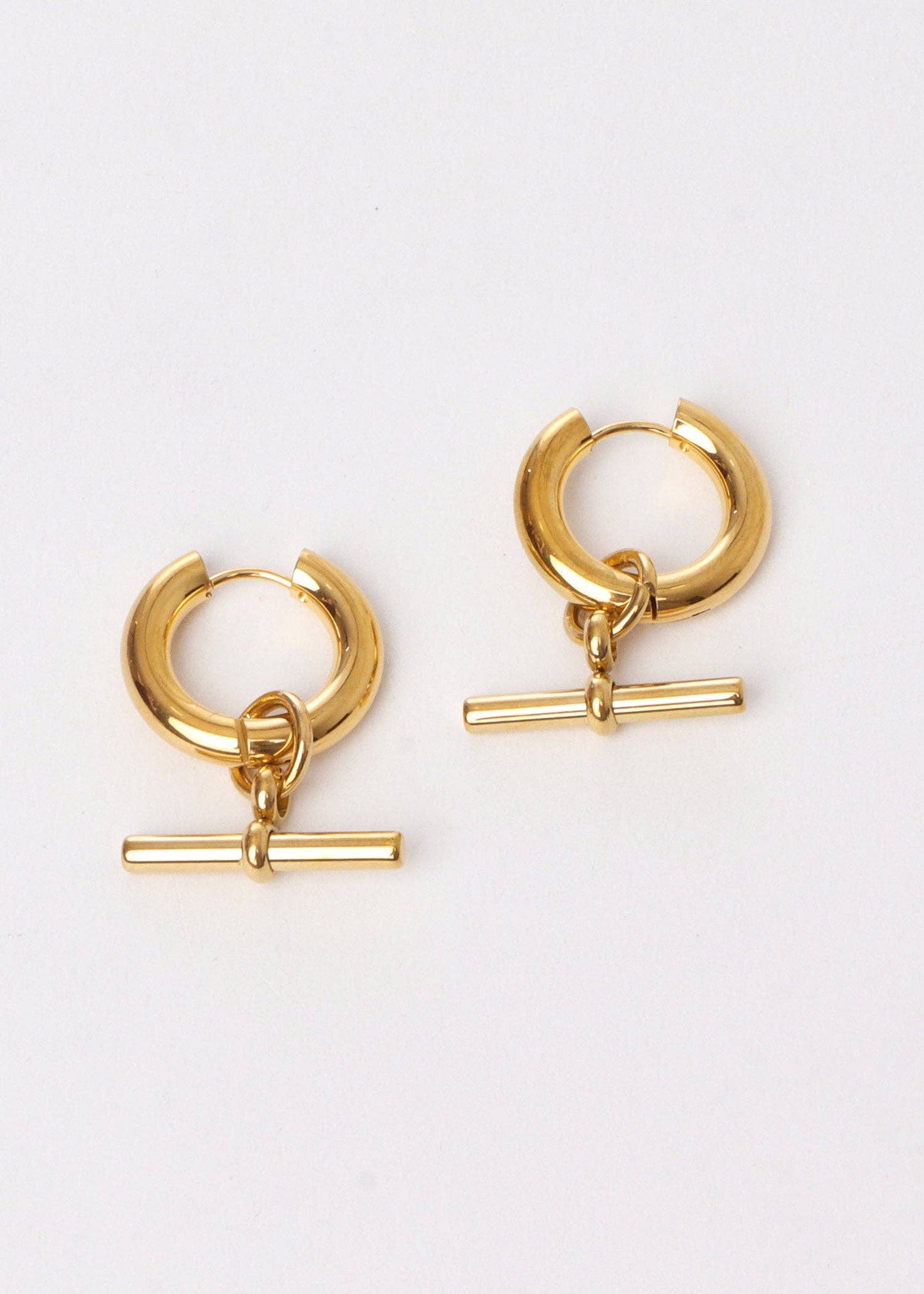 Gold hoop earrings with additional gold bars on a white background