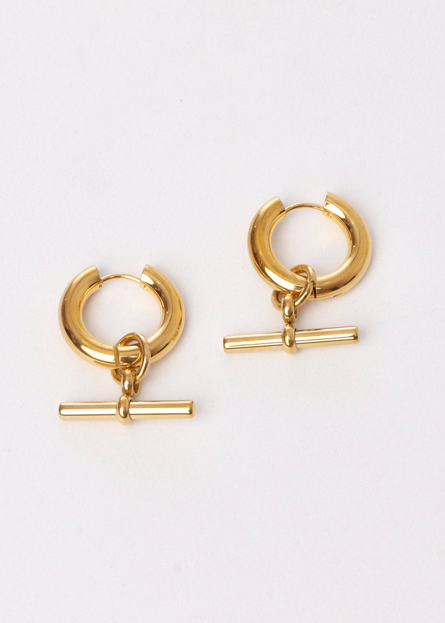 Gold hoop earrings with additional gold bars on a white background