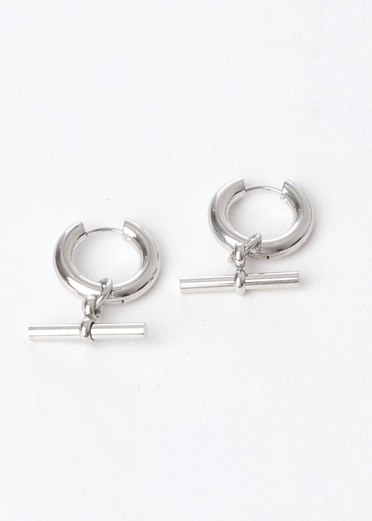 Pair of silver hoop earrings with horizontal bars on a white background