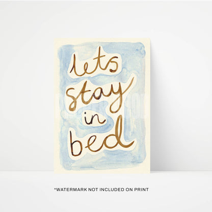 Card with 'Let's stay in bed' text on a watercolor background
