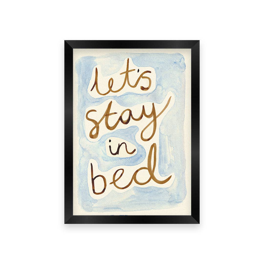 Framed artwork with 'Let's stay in bed' text on a watercolor background