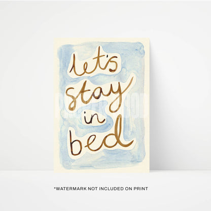 Card with 'Let's stay in bed' text on a watercolor background