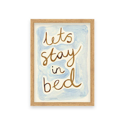 Framed artwork with 'let's stay in bed' text on a watercolor background