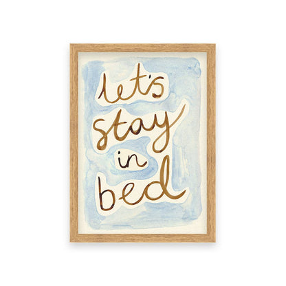 Framed artwork with 'Let's stay in bed' text on a watercolor background
