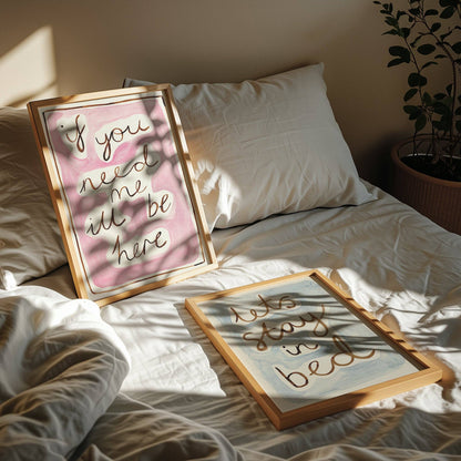Two framed quotes on a bed with sunlight casting shadows