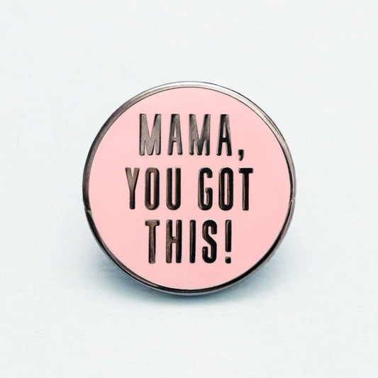 Pink enamel pin with 'Mama, you got this!' text on a light gray background