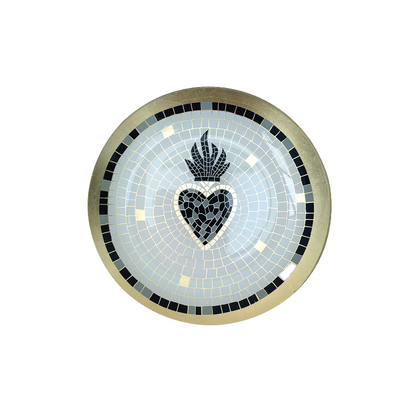A round mosaic decorative plate featuring a central black heart with a flame motif above it, surrounded by a light blue mosaic field and a gold-toned outer border with black accents.