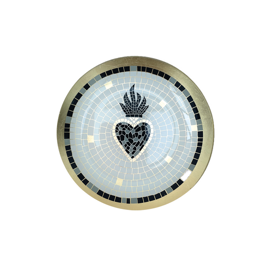 A round mosaic decorative plate featuring a central black heart with a flame motif above it, surrounded by a light blue mosaic field and a gold-toned outer border with black accents.